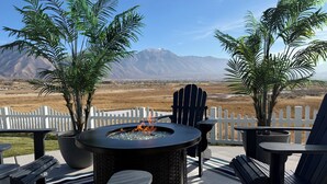 A patio with a fire pit, Adirondack chairs, and potted plants. - Magical Mountain-View Retreat SwimSpa-Hot Tub , Fire pit & Cozy Living Spaces  (Salem)