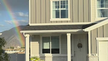 A two-story house with a front porch, a mailbox, and a number '263' on the door.
