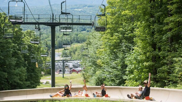A ski lift with chairs and a curved track. - Cozy Ludlow, Vermont Farmhouse Ski Retreat with hot tub and fire pit (Ludlow)