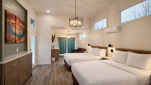 A hotel room with two beds, a wooden dresser, a painting, and a view of the outdoors. - Ultra Luxury Tiny Home with Deck #1B (Page)