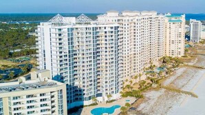 A high-rise hotel with multiple balconies, a swimming pool, and a beach area. - Palacio 403 | Beachfront | My Beach Getaways (Pensacola)