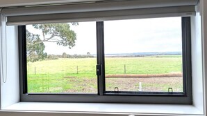 A kitchen with a window, a sink, and a faucet. - The Duck House: Modern, Rural, 3 min drive to town (Kingscote)