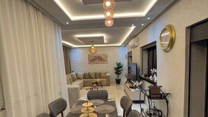 A modern dining area with a rectangular table, multiple chairs, and a ceiling light fixture. - Rooftop & Cinema - Luxury in the heart of Marrakech (Marrakesh)