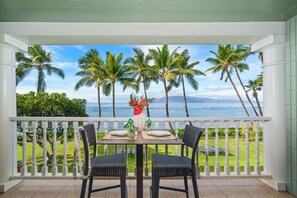 A balcony with a view of palm trees and the ocean. - Oceanfront Studio w Lanai, AC & Sunset Views Pool & Hot Tub - Lahaina Shores 229 (Lahaina)