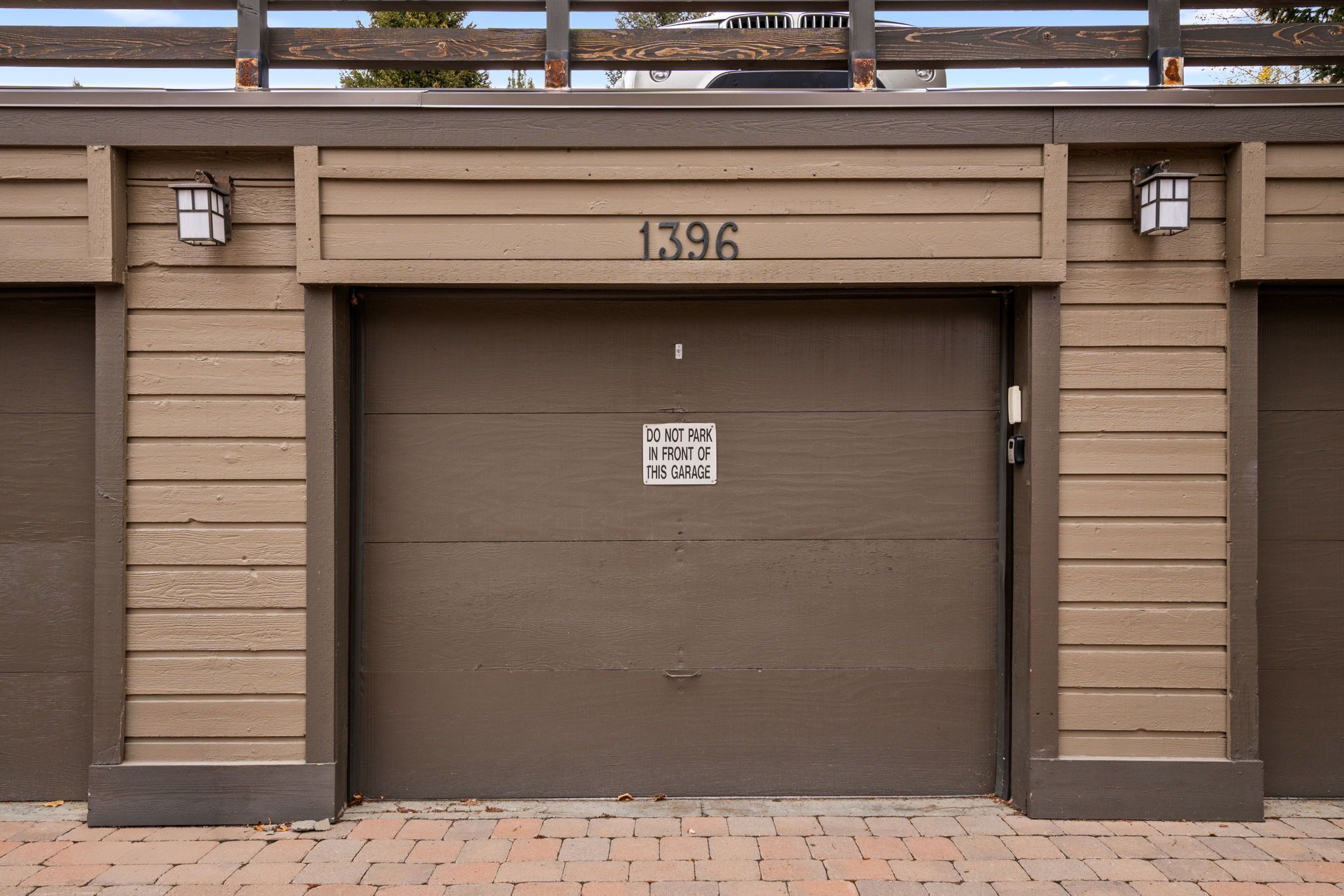 A closed garage door with the number 1396 and a 'DO NOT PARK IN FRONT OF THIS GARAGE' sign.