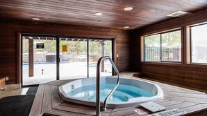 A hot tub with a wooden deck, a metal ladder, and a 'NO DIVING' sign. - Walk to Canyons Village Charm: Vintage-Inspired Interiors, Private Patio,  Shared Pool (Park City)