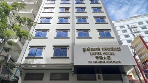 A multi-story building with a sign indicating it is an "Empire House" hotel. - Empire House Phnom Penh (Phnom Penh)