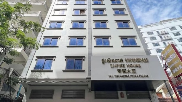 A multi-story building with a sign indicating it is an "Empire House" hotel. - Empire House Phnom Penh (Phnom Penh)