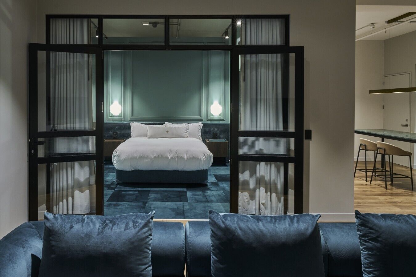Une chambre moderne avec un grand lit, un bureau et une chaise, le tout dans un espace séparé.