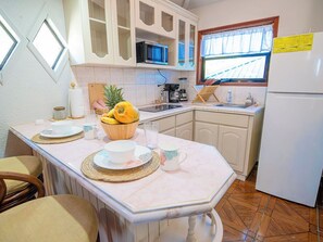 Fridge, microwave, stovetop, coffee/tea maker - West Bay • King Bed • Kitchen • Living Room • Pool (West Bay)