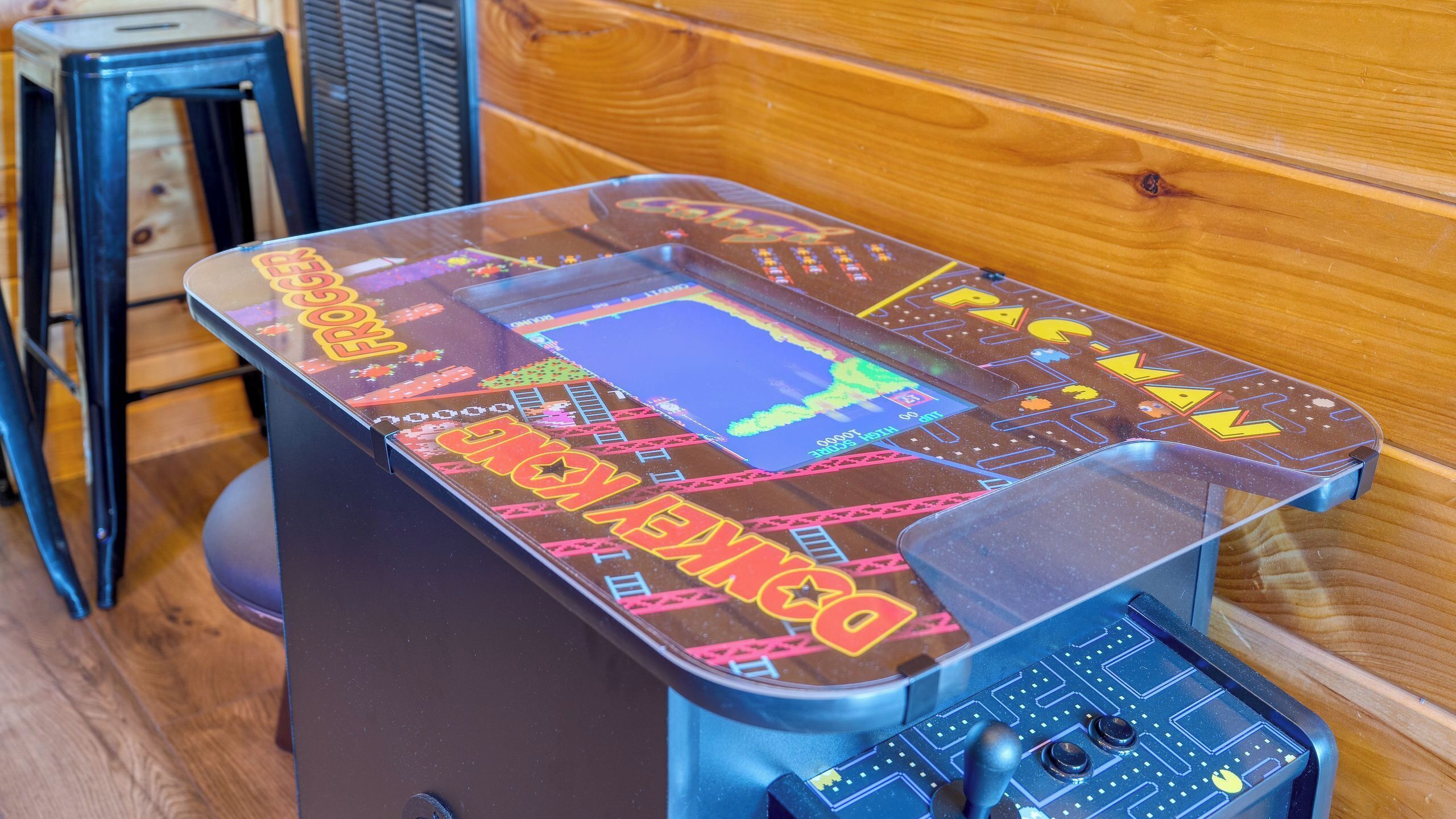 A retro arcade machine with colorful graphics and a joystick.