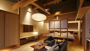 A modern hotel room with a wooden floor, a sofa, a desk, and a bed. - Umioto Mari (Shodoshima)