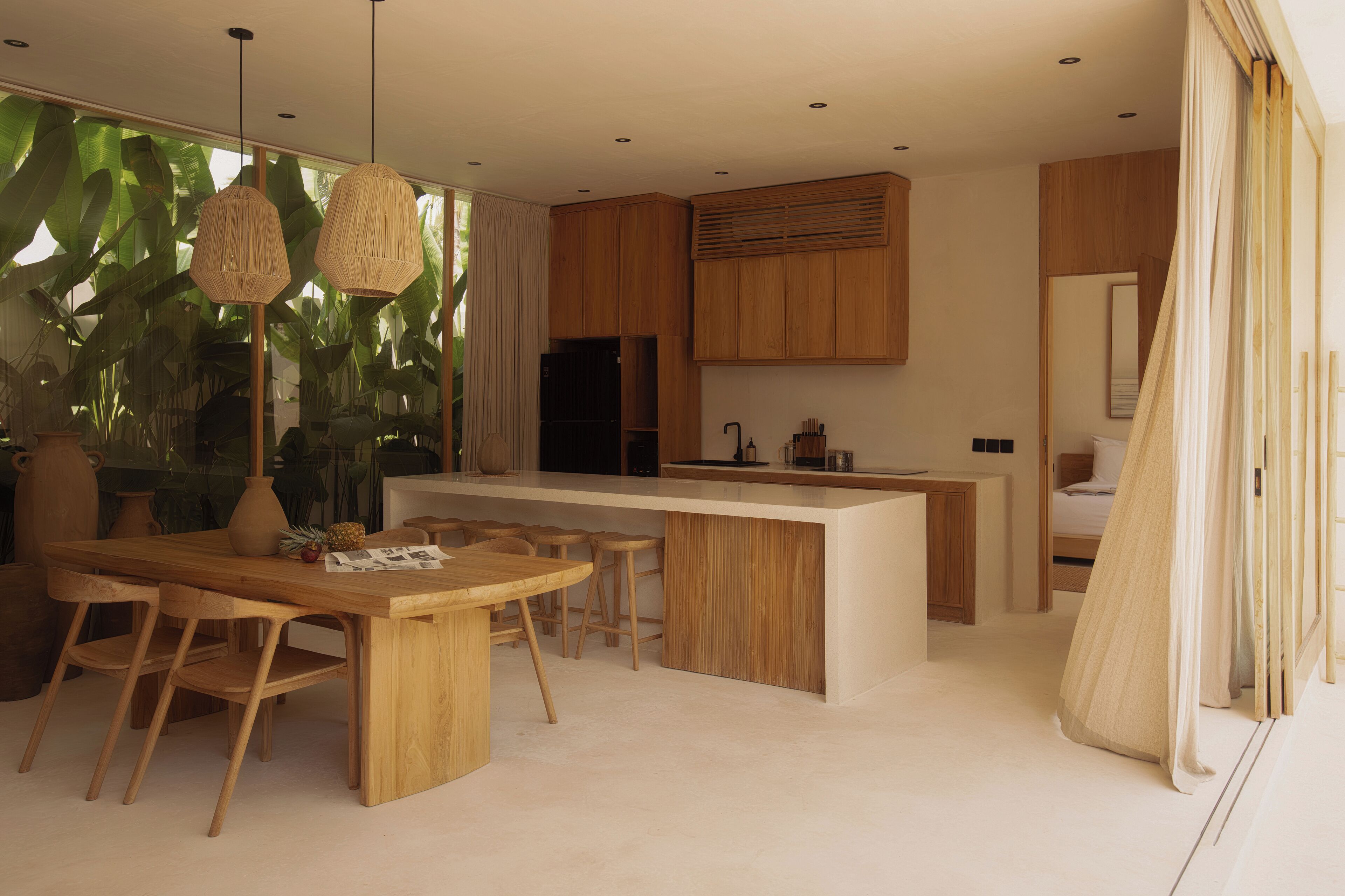 A modern kitchen with wooden cabinetry, a central island, and pendant lighting.