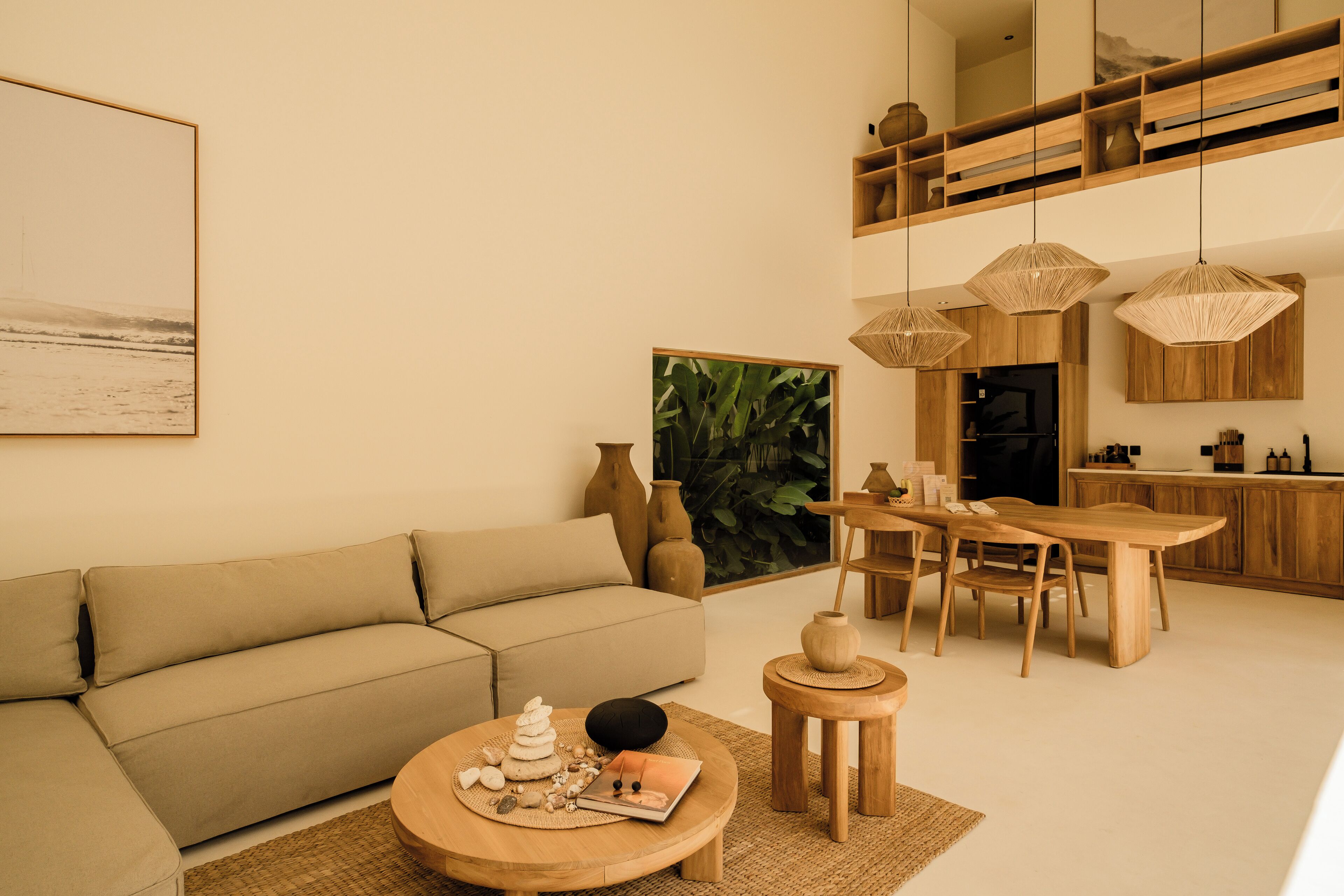 A modern living room with a sofa, coffee table, and dining area.