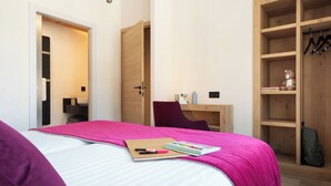 A bedroom with a bed, a desk, a chair, and a wardrobe. - MGM Hôtels et Résidences - Hotel Alhena (Magland)