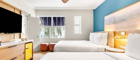 A hotel room with a bed, bedside table, lamp, TV, wardrobe, and a window with a view of palm trees.