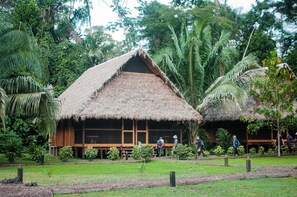 A thatched-roof hut with wooden walls and a bench outside. - Amazon Field Station Byinkaterra (Tambopata)