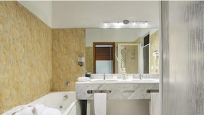 A bathroom with a marble vanity, a bathtub, and a large mirror. - Relax Hotel Acquaviva - Tuscany Hills (Casole d'Elsa)