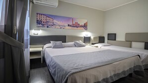 A hotel room with two beds, a painting of a cityscape, an air conditioner, and bedside lamps. - Relax Hotel Acquaviva - Tuscany Hills (Casole d'Elsa)
