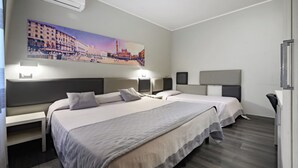 A hotel room with two beds, a large cityscape painting on the wall, and a desk with a chair. - Relax Hotel Acquaviva - Tuscany Hills (Casole d'Elsa)