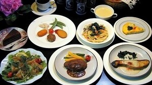 A variety of dishes on plates, a coffee cup, and bottles of a beverage. - Pension Mori no Symphony (Shinano)