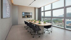 A modern conference room with a large table, chairs, and a city view through large windows. - Pagoda Hotel, Baoan,qianhai, Shenzhen (Shenzhen)