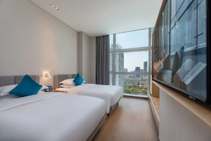 A hotel room with two beds, a large window with a city view, and a flat-screen TV. - Pagoda Hotel, Baoan,qianhai, Shenzhen (Shenzhen)