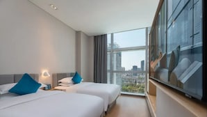 A hotel room with two beds, a large window with a city view, and a flat-screen TV on a stand. - Pagoda Hotel, Baoan,qianhai, Shenzhen (Shenzhen)
