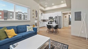 A modern apartment with a living room, kitchen, and dining area. - Modern Apartment + Balcony (Fort Collins)