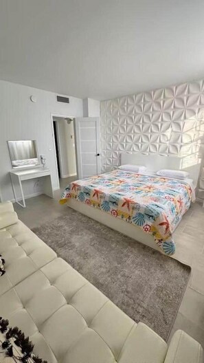 Ein Schlafzimmer mit einem Bett, einem Schreibtisch und einem Sofa.