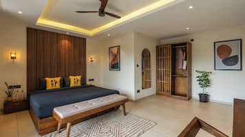 A modern bedroom with a large bed, a ceiling fan, and a wooden wardrobe.