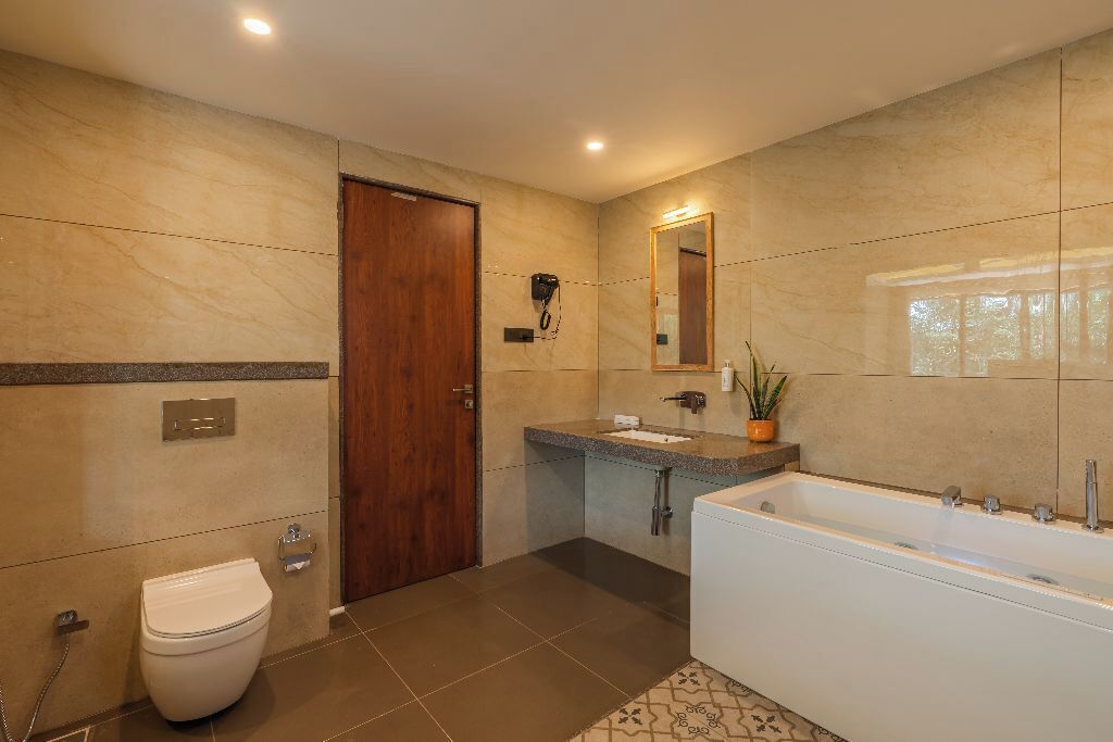 A modern bathroom with a toilet, sink, and bathtub.