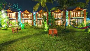 A hotel with multiple two-story buildings, each featuring balconies and large windows. - Padma Luxury Resort MawaGhat Dhaka (Louhajang)