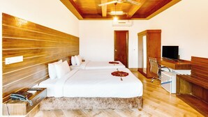 A hotel room with two beds, a wooden ceiling, a desk with a TV, and a telephone. - Padma Luxury Resort MawaGhat Dhaka (Louhajang)