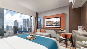 A modern hotel room with a large bed, a desk, a chair, a TV, and a city view. - From.K Hotel (Guangzhou Tianhe Zhengjia Plaza Tiyuxi Road Metro Station Branch) (Guangzhou)