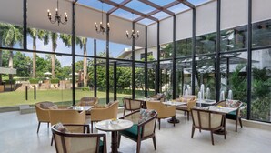A spacious indoor area with large windows, comfortable seating, and a view of the outdoors.
