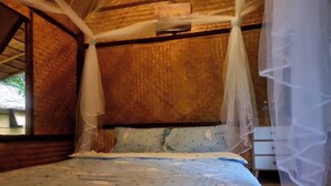 A bed with a canopy, a window, and a wooden wall. - Koh Kood Good Time (Ko Kood)