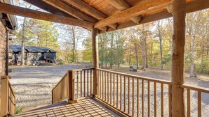 A wooden porch with a gravel path leading to a building. - Kentucky Lake Access! Family Log Cabin w/ Deck (Murray)