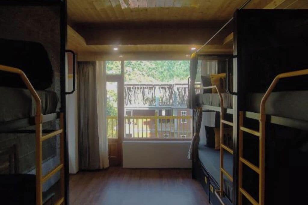 A bunk bed room with a view of the outdoors.