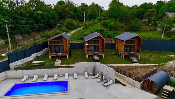 A pool area with lounge chairs and a small pool. - Sioni Hillside Cottages (Sioni)