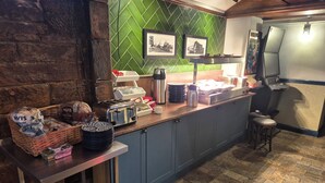 A kitchen with a herringbone green backsplash, a toaster, and a coffee maker on the counter. - The Old Victoria (Penrith)