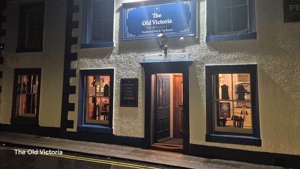 The Old Victoria, a traditional pub with a signboard, two visible entrances, and a small display window. - The Old Victoria (Penrith)
