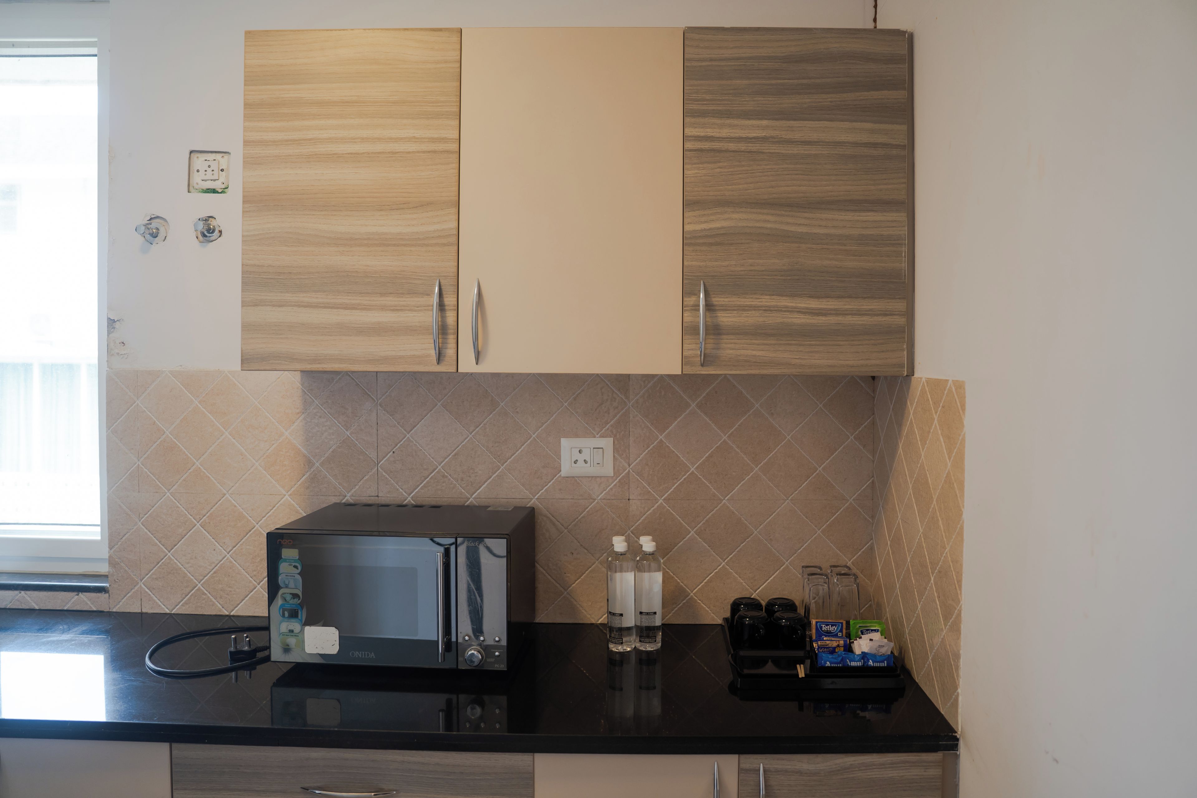 A kitchenette with a microwave, a coffee maker, and a water dispenser.