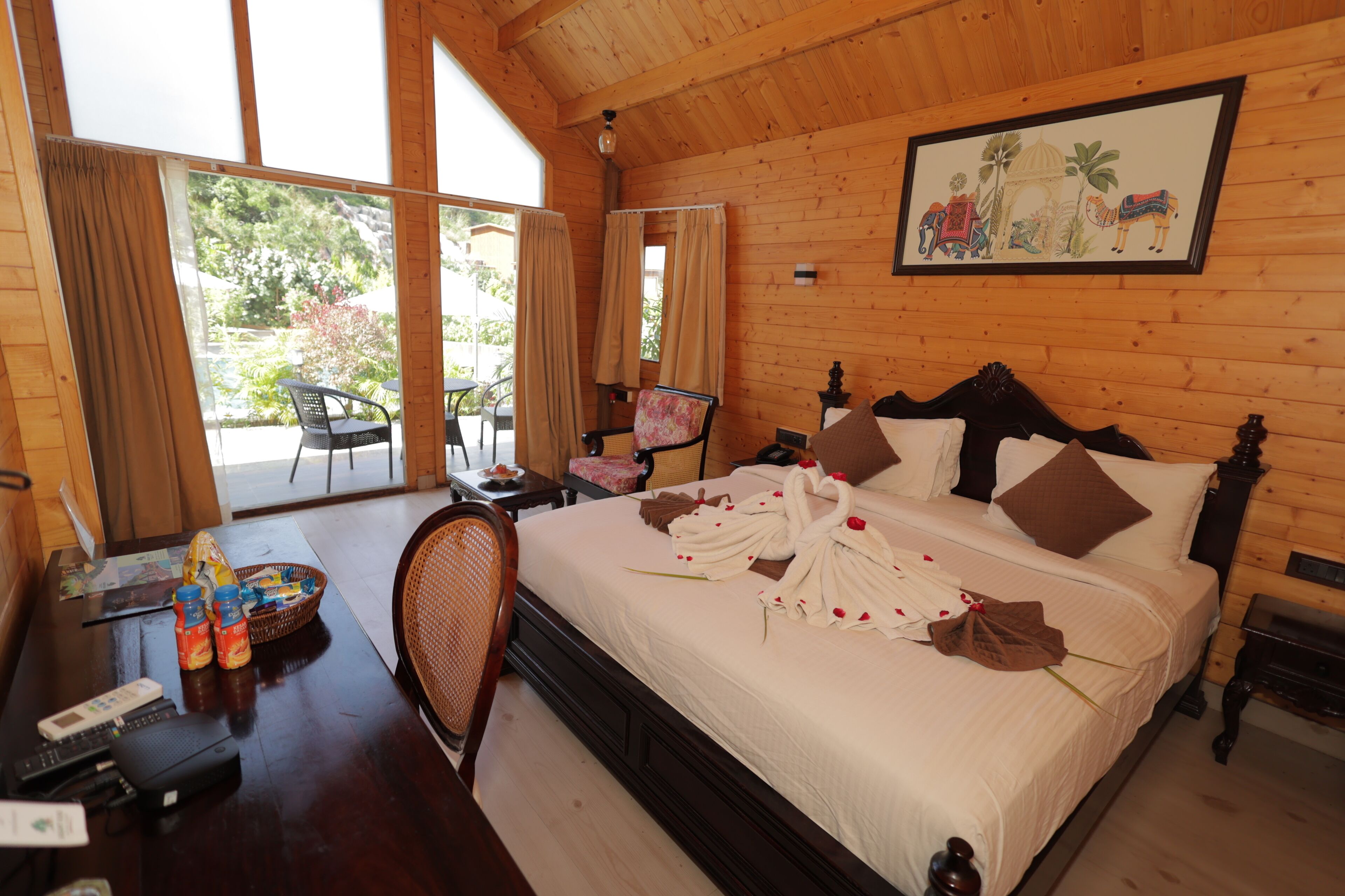 A wooden room with a bed, a desk, and a chair.
