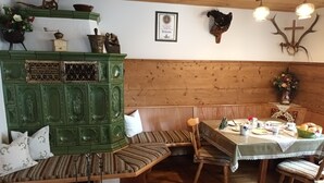 A traditional wooden interior with a bench, table, and decorative items. - Vacation apartment 85 sqm with terrace (Rottau)