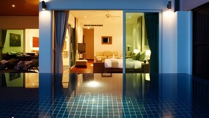 A hotel room with a glass partition, a bed, a desk, and a chair. - Kamala Falls 3BR Seaview w Private Pool (Kamala)