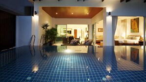 A modern hotel interior with a swimming pool, a dining area, and a bedroom. - Kamala Falls 3BR Seaview w Private Pool (Kamala)