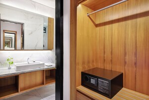 A modern bathroom with a marble sink, wooden vanity, and a built-in radio.