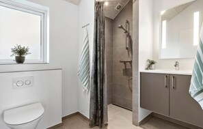 A modern bathroom with a shower, toilet, and sink. - Nice home in Glesborg with sauna (Glesborg)