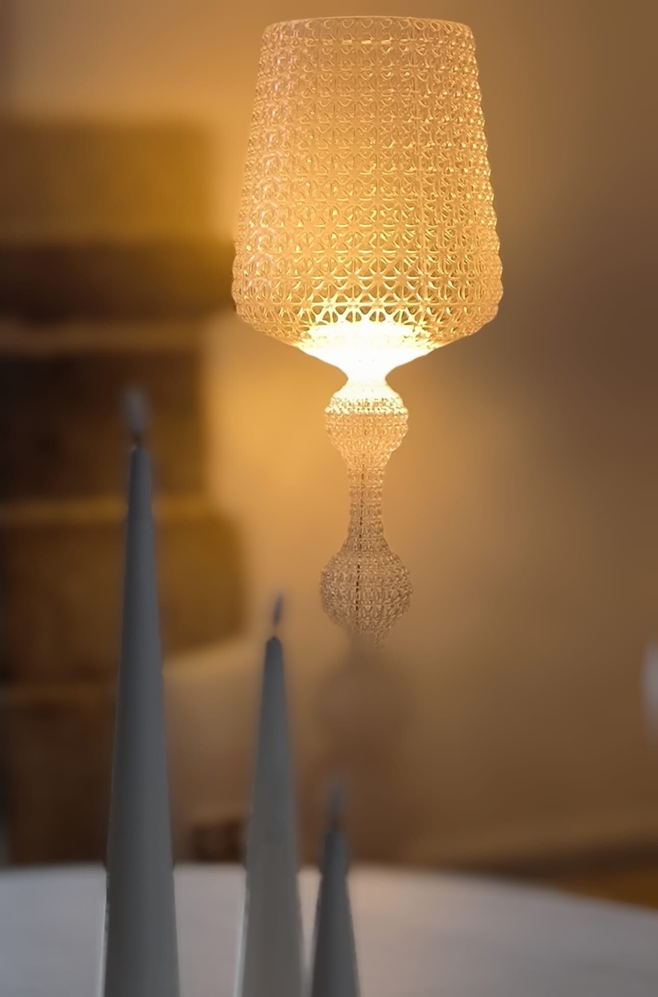 A hanging lamp with a detailed, geometric pattern.